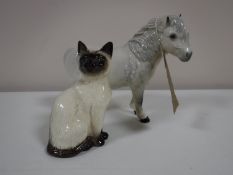 A Royal Doulton figure of a pinto pony, grey, together with a Beswick Siamese cat No.