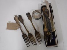A sterling silver handled cheese knife, a silver napkin rings and five silver forks,