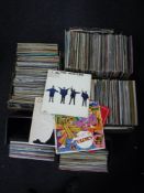 Three boxes and two cases containing vinyl records including The Beatles, Electric Light Orchestra,
