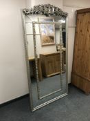 An ornate silvered mirror, 197cm x 100cm