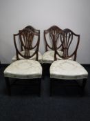 A set of four mahogany shield back dining chairs