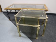 A contemporary glass top coffee table on metal legs,