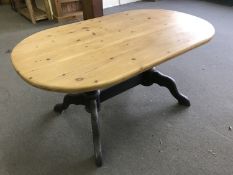 An oval pine kitchen table on painted base