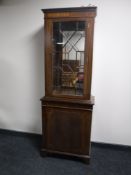 An inlaid mahogany Regency style display cabinet fitted a cupboard beneath