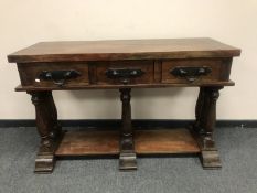 An Eastern hardwood, three drawer console table,