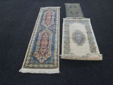 A fringed Chinese floral embossed rug on cream ground,