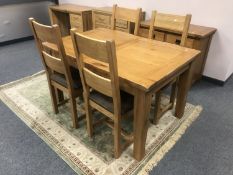 A good quality oak contemporary extending dining table and four ladder back chairs,