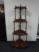 A mahogany four tier corner whatnot stand