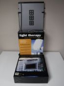 A wall mounted Morphy Richards trouser press, together with a boxed therapy light,