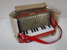 A Goldentone child's size accordion,