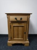A stripped pine bedside cabinet fitted a drawer