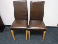 A pair of contemporary brown leather dining chairs