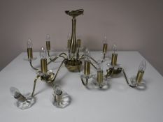 A contemporary brass eight-way light fitting together with a pair of matching wall lights