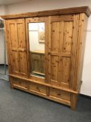 A pine triple door mirrored wardrobe,
