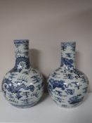 A large pair of Chinese blue and white bulbous vases with dragon decoration,
