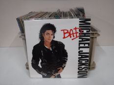 A box and a case containing LP's, including 80's, Wet Wet Wet, Michael Jackson, The Beatles,