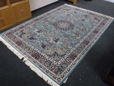 A Turkish machine made floral carpet on green ground