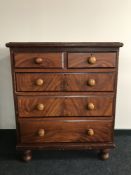 An antique pine five drawer chest