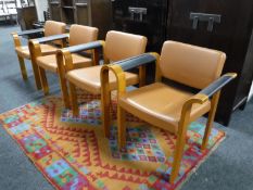 A set of four stained beech framed office armchairs
