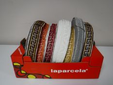 A box containing vintage Silver Cross pram trim (eight spools)