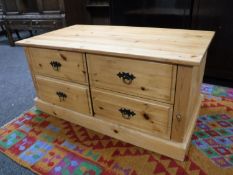 A pine storage coffee table fitted four drawers