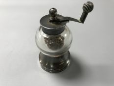 A silver and glass pepper mill CONDITION REPORT: The mechanism works.
