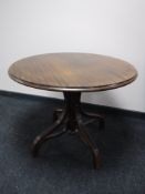 A circular bentwood pedestal table