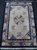 A fringed Chinese rug on cream ground, 123 cm x 183 cm.