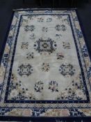 A fringed Chinese rug on cream ground, 275 cm x 184 cm.