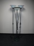 Three metal floor lamps and a wicker dining chair