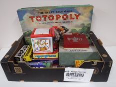 A box containing vintage board games including Totopoly, Escalado, Wembley Board Game,