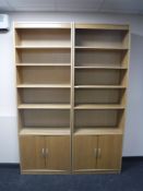 Two sets of contemporary open bookshelves fitted cupboards beneath