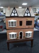 A dolls house on stand together with a dolls bungalow
