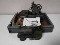 A box containing a live steam engine and assorted components including a Stuart gauge