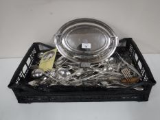 A silver plated lidded entree dish together with a basket of a large quantity of plated flatware