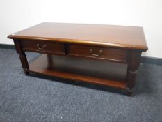 A reproduction mahogany coffee table fitted two drawers with undershelf