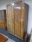 An early 20th century walnut double door wardrobe