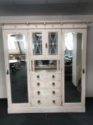 A late Victorian painted mirror door wardrobe fitted with drawers