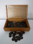 A wooden box containing a collection of Georgian pennies and assorted coinage