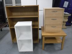 A set of contemporary open bookshelves, a three drawer beech effect chest,