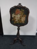A Victorian mahogany tapestry screen on a tripod base