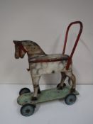 An early twentieth century hand painted children's push along horse