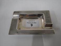 A silver ashtray with engine turned decoration,