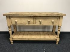 A reclaimed pine two drawer kitchen table with undershelf