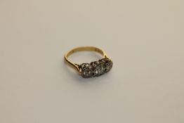 A three stone diamond ring set in 18ct gold