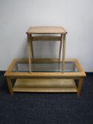A contemporary two tier glass top coffee table together with a contemporary occasional table