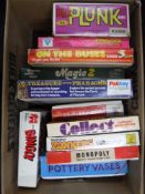 A box containing vintage board games, including Family Fortunes, Treasure of The Pharaohs,