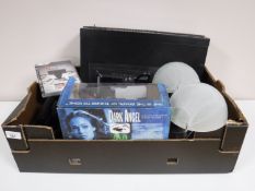 A box containing a Morantz compact disk player with remote, Playstation 3 controllers,