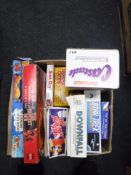 A box containing vintage board games, including Hungry Hippos, Downfall, Matchbox Cascade,