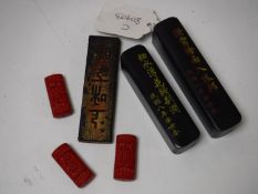 Two Chinese lacquered desk pots, each containing seals,